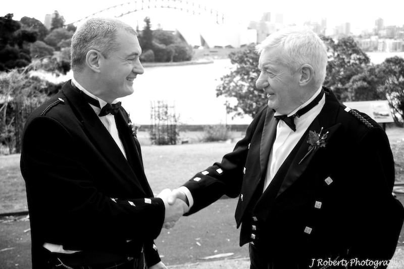 Groom and father shacking hands - wedding photography sydney
